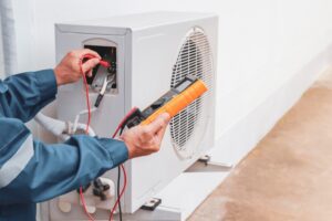 A person is working on an air conditioner.