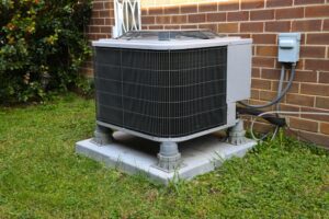 A large air conditioner sitting outside of a house.