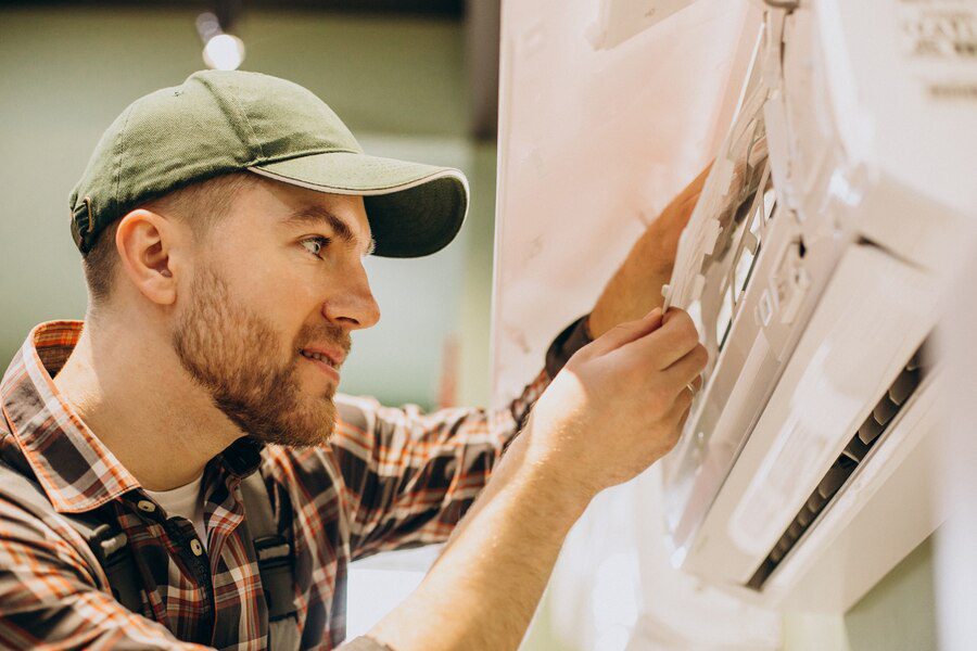 A man in plaid shirt and hat holding scissors.