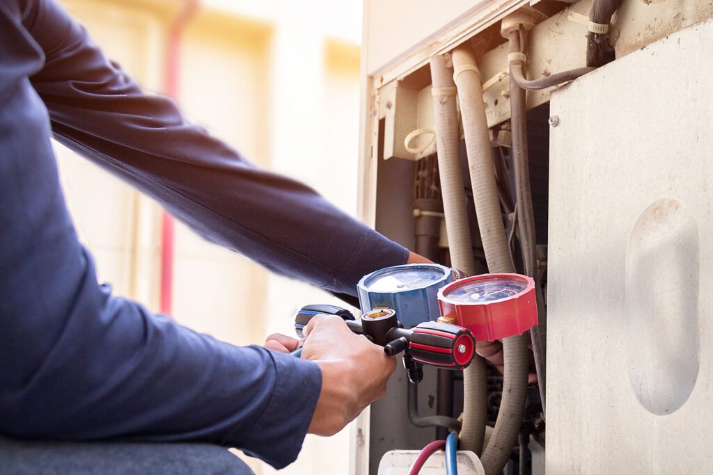 A person is working on an air conditioner.