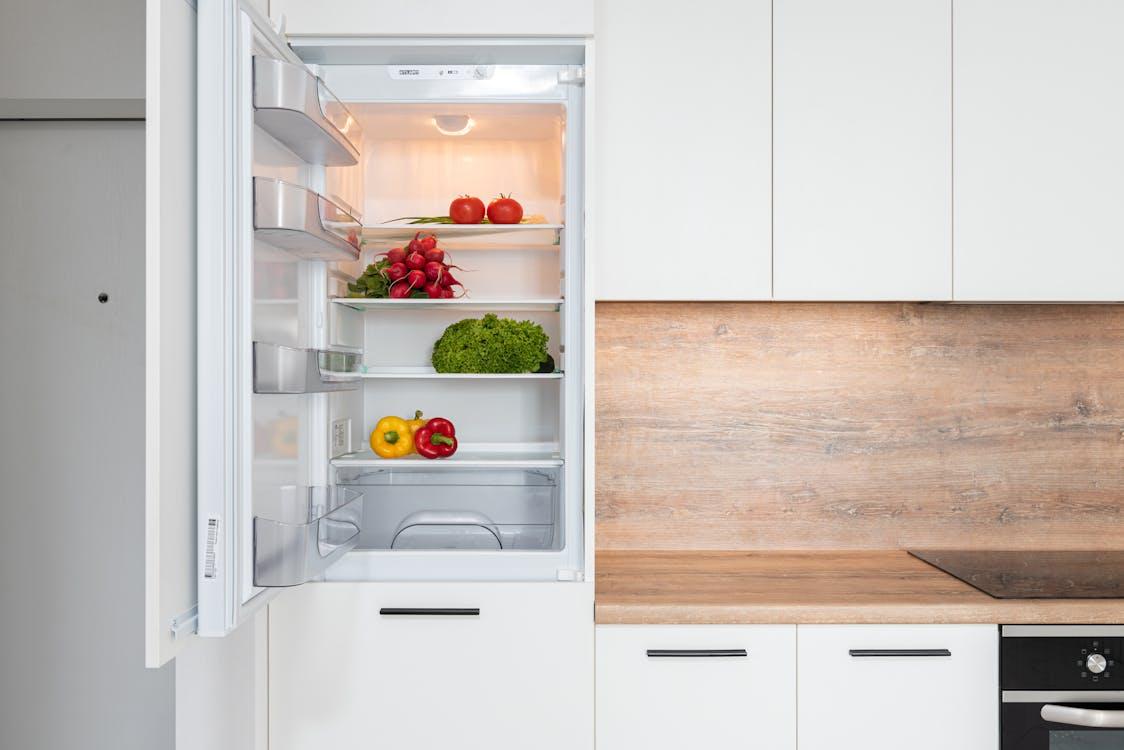 A fridge with colorful vegetables inside